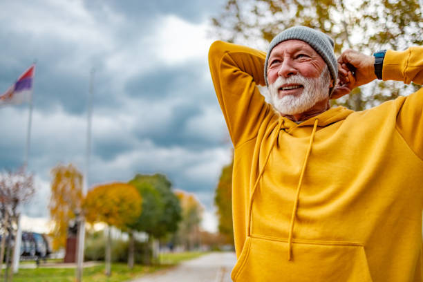 istock Senior man stretching in a park 1830344166