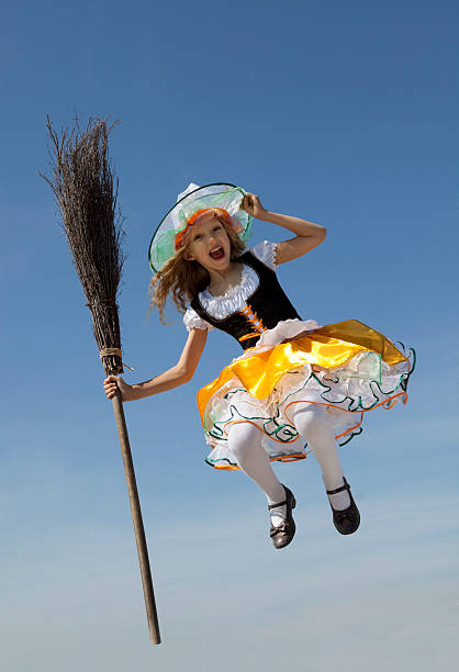 Happy Little Witch Jumping with a Broom