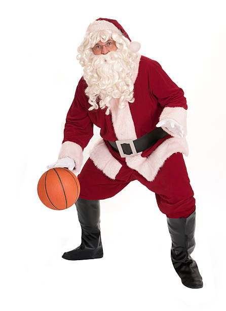 Santa Claus dribbling a basketball.  Isolated on white.
