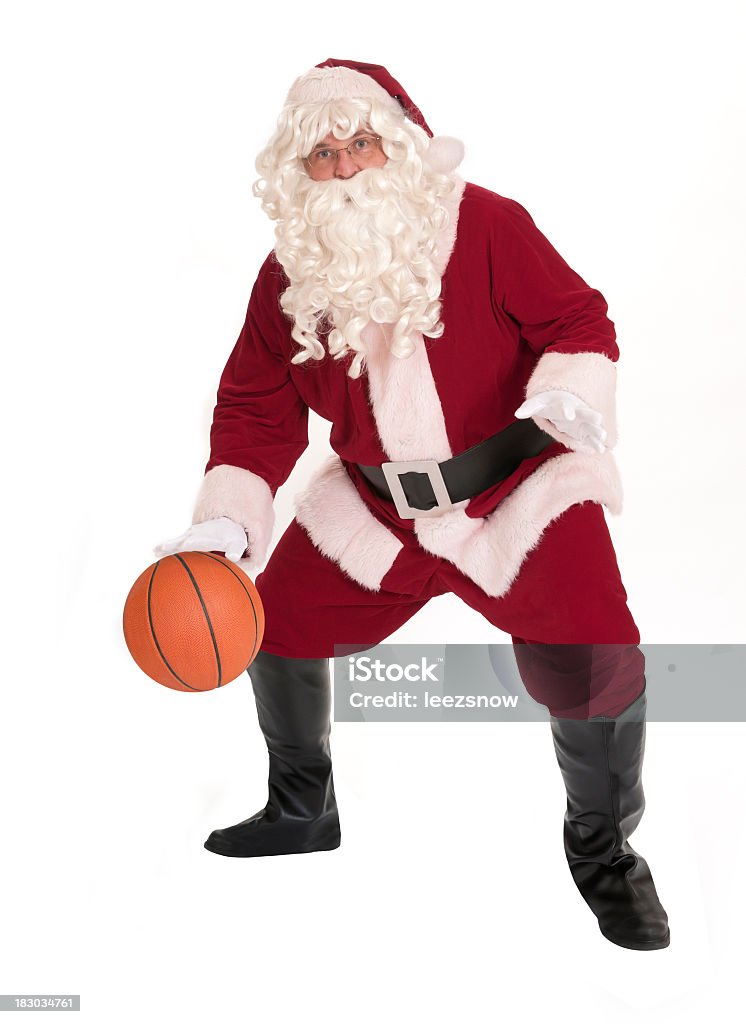 Santa playing basketball on white background Santa Claus dribbling a basketball.  Isolated on white. Basketball - Sport Stock Photo