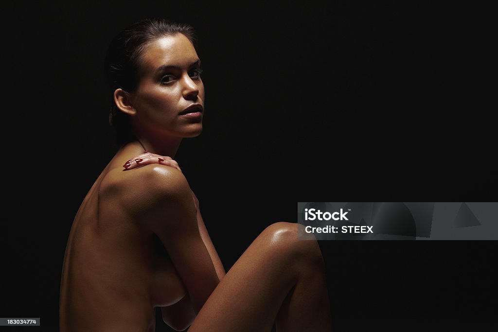 Joven desnudo aislado sobre fondo negro - Foto de stock de 20 a 29 años libre de derechos