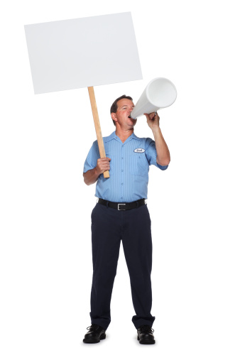 Striking or protesting blue collar worker holding a blank sign and yelling into a megaphone. To see more blue collar workers click on the link below: