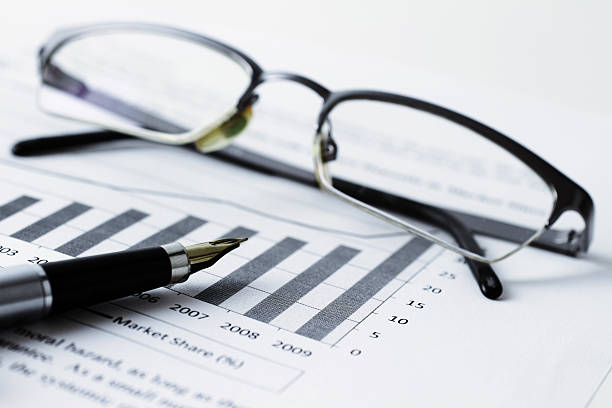 istock Spectacles and pen on top of a bar chart document 183035017