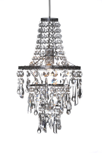 Beautiful crystal chandelier on black background. Vertical photo.