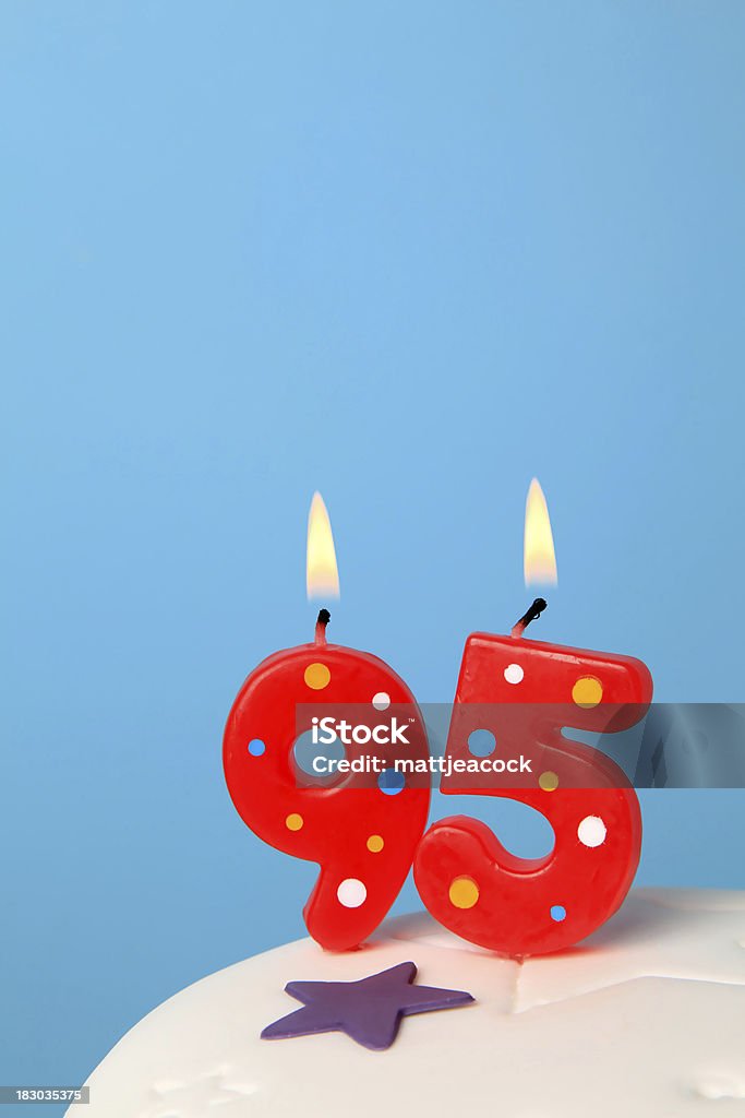 95th Birthday candles Red Birthday candles against blue background Anniversary Stock Photo