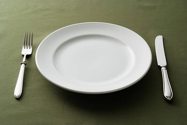 Close-up shot of place setting on green tablecloth.
