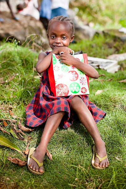 istock African Girl Holding Gift Bag 183036397