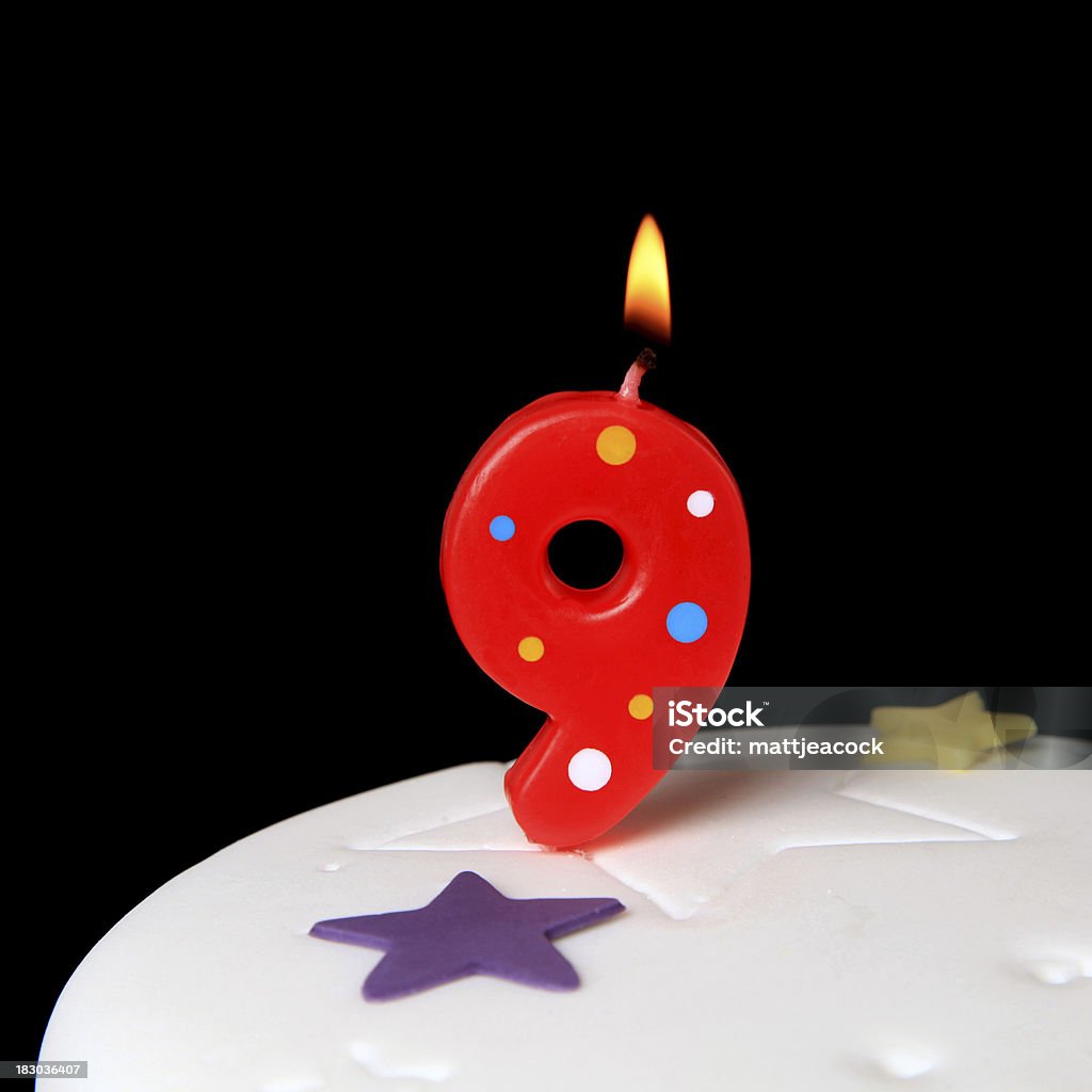 9th Birthday candle Red Birthday candles against black background Anniversary Stock Photo