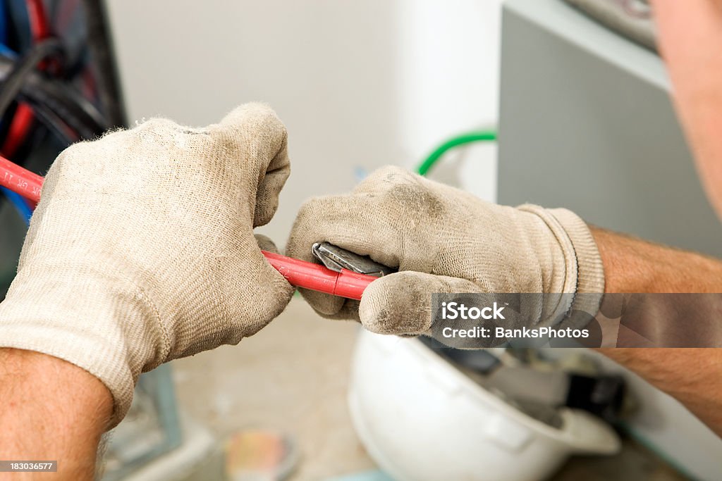 Electrician Stripping Red (Hot) Wire with a Utility Knife  Utility Knife Stock Photo