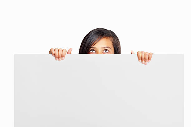 istock Girl holding blank board and looking up on white background 183036750