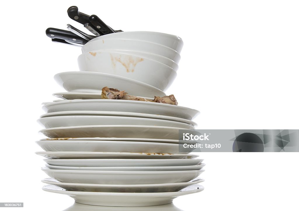 Stack of white dirty dishes on a white background A pile of dirty dishes on white. Washing Dishes Stock Photo