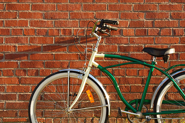 istock Vintage Bicycle Leaning Against Red Brick Wall In Summer 183036949