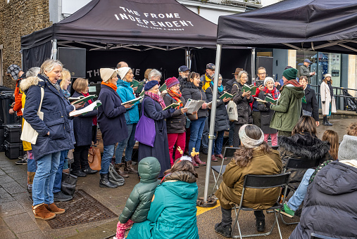 Christmas choir perfroming at Frome Christmas Sunday Market in Frome, Somerset, UK on 3 December 2023