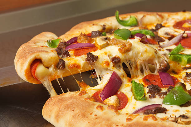 Meat and Vegetable Stuffed Crust Pizza Horizontal composition of a meat and vegetable pizza with a stuffed crust. stuffed crust pizza stock pictures, royalty-free photos & images