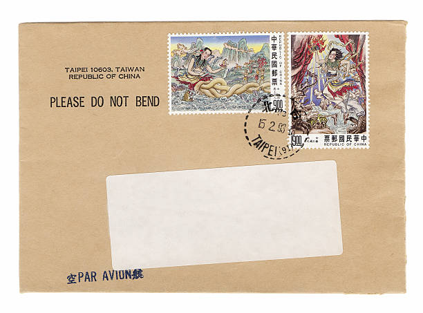 Vintage envelope from Taipei with Chinese postage stamps. Postmarked Taipei. Blank white address label on brown manila envelope. On white background. International mail. Correspondence. Ephemera.More envelopes: