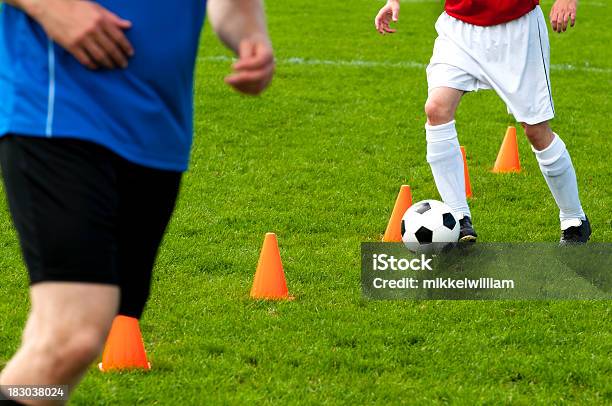 Soccer Players Warm Up And Run Past Cones With Ball Stock Photo - Download Image Now