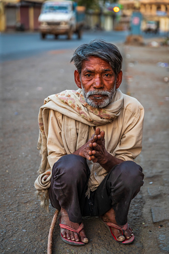 Beggar sitting against a wall