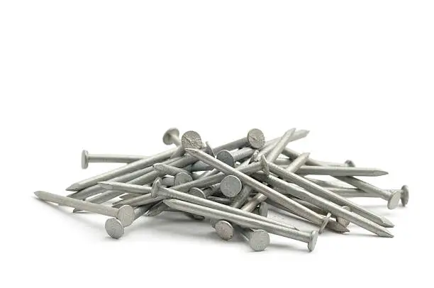 A small pile of galvanised nails isolated on white.