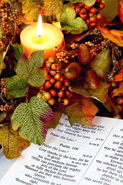 Religious: Thanksgiving Bible Scripture with Candle and fall decor stock photo