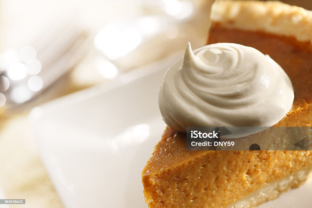 Pumpkin Pie A dollop of whipped cream on a slice of pumpkin pie.To see more of my Thanksgiving images click on link below: Thanksgiving - Holiday Stock Photo