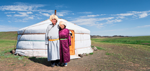 Mongolian couple in national clothing, ger (yurt) in the background.http://bem.2be.pl/IS/mongolia_380.jpg