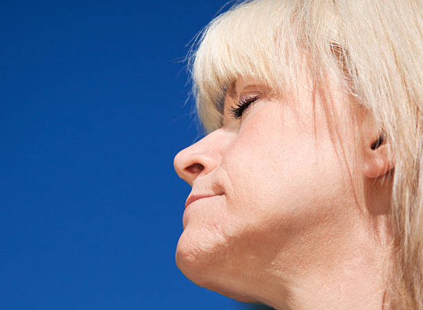 istock Blond Female Eyes Closed Face to the Sun 183038732