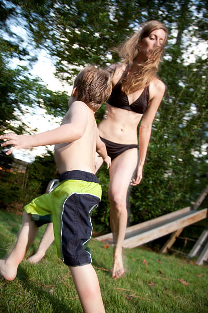 istock Little boy running around a woman 183038906