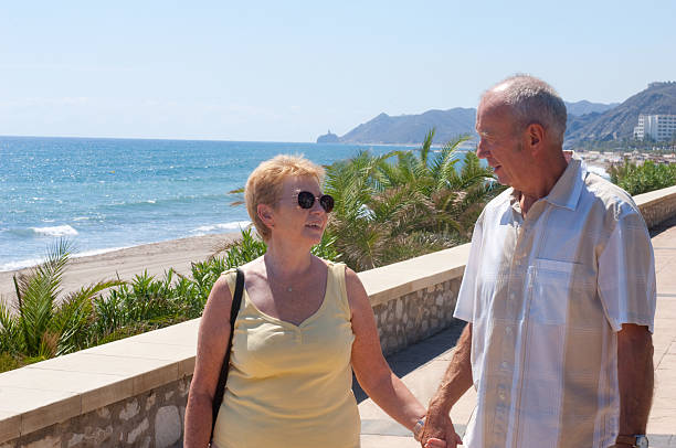 istock senior couple walking on holiday 183039188