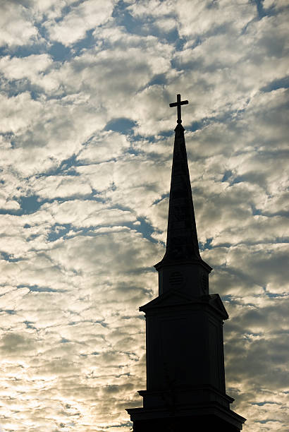 istock Church Steeple with Cross, Silhouette Against Dramatic Sky 183039571