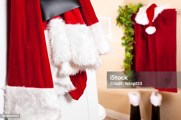 Santa Suit Hanging On Bathroom Door Boots Hat Stock Photo - Download Image Now - Bathroom, Beauty, Boot