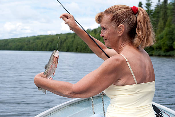 fish in hand - mature woman having fish bildbanksfoton och bilder