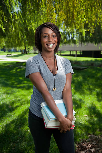 istock Pretty Young Student in Park with Books 183040843
