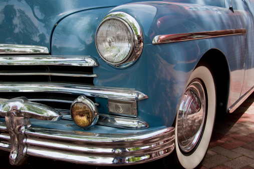 A restored blue Plymouth automobile.