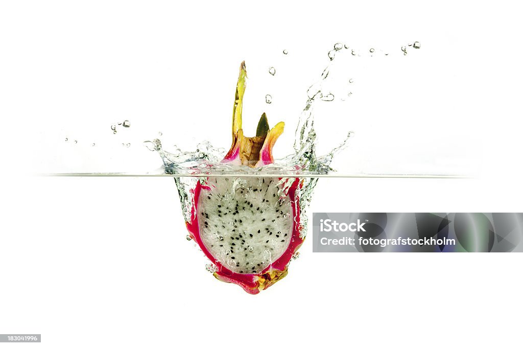 Fresh dragon fruit water splash Fresh half of tropical exotic dragon fruit splashing into clear fresh water. Copy Space Stock Photo