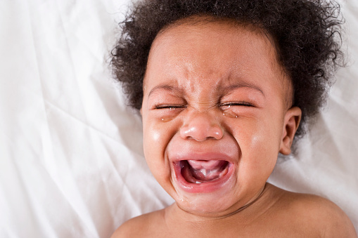 Face of crying African American baby, 6 months old