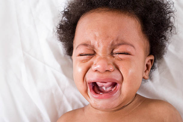 Face of crying African American baby Face of crying African American baby, 6 months old mouth open human face shouting screaming stock pictures, royalty-free photos & images