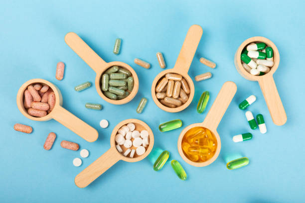 istock Vitamins and supplements. Variety of vitamin tablets on a blue background. Multivitamin complex for every day. Nutritional supplements.Copy space.Vitamins for immunity 1830425193