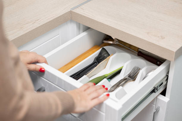 istock woman's hand opens a kitchen drawer with cutlery 1830425202