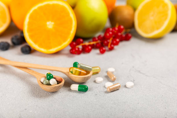 istock Vitamins and supplements. Variety of vitamin tablets on background. Multivitamin complex for every day. Nutritional supplements.Copy space.Vitamins for immunity 1830425220