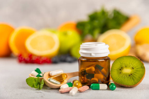 istock Vitamins and supplements. Variety of vitamin tablets on background. Multivitamin complex for every day. Nutritional supplements.Copy space.Vitamins for immunity 1830425222