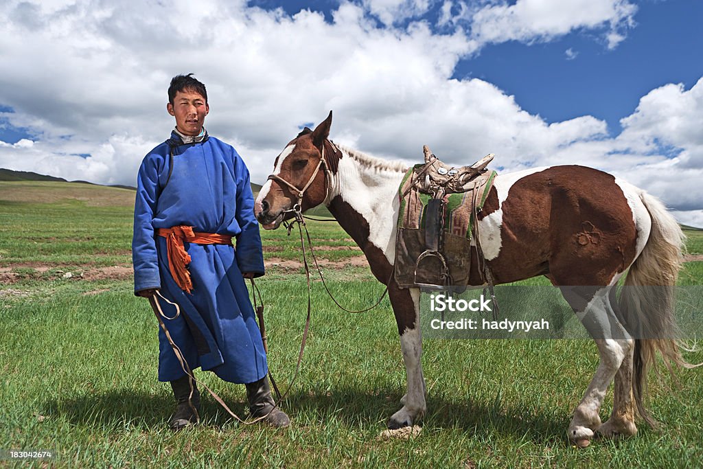 Mongolian horseback rider Mongolian horseback rider, hills in the background.http://bem.2be.pl/IS/mongolia_380.jpg Independent Mongolia Stock Photo