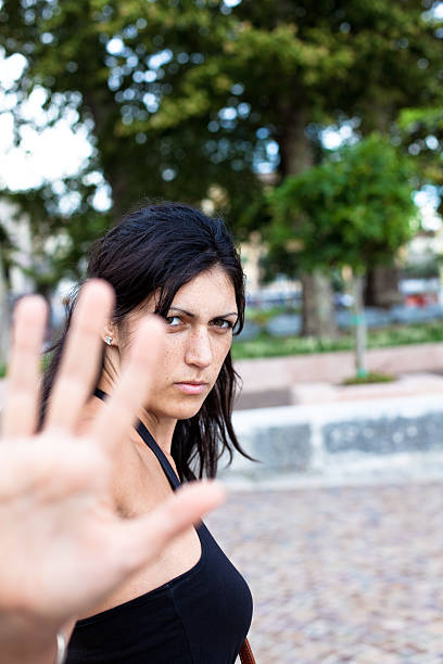 istock Young Woman in Public Park Protecting herself from Aggression 183042770