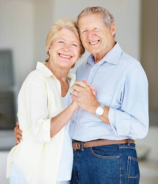 istock Smiling elderly couple at home embracing each other 183042783