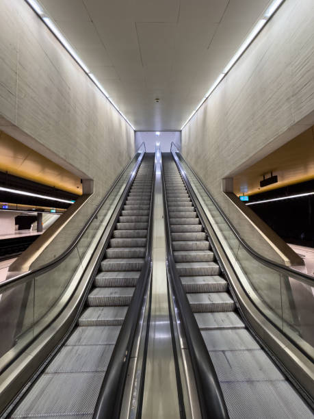 istock Underground public escalators - no people 1830430557