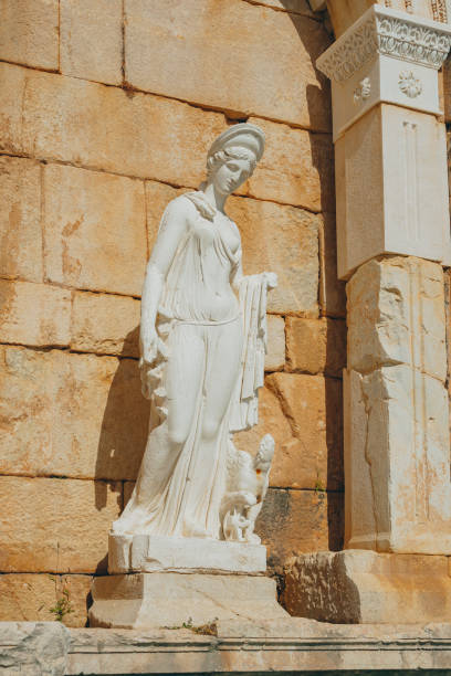 Carved marble relief of the Roman goddess Minerva in the shrine of the four gods ( Sacello dei Quattro dei ) at Ancient City of Herculaneum, Campania, Italy\nHerculaneum Italy\nHerculaneum Scavi - Sacellum of the Four Gods Relief, showing Mercury. Restored after the earthquake in 62 AD, the temple is dedicated to four divinities, as evidenced by the lovely archaistic reliefs,  from the Augustan period ( 27 BC- AD14 )