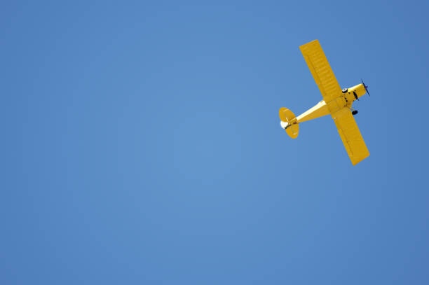 istock Yellow Airplane on Blue Sky 183043540
