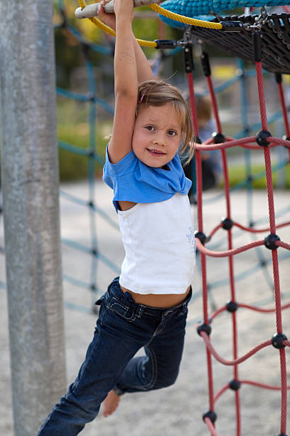 istock girl swinging on rope 183043650