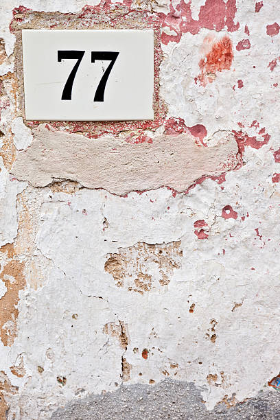 istock 77, Street Number On The Wall 183043942