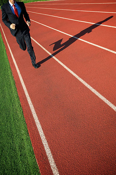 istock Businessman Runs Along Sports Track 183044007
