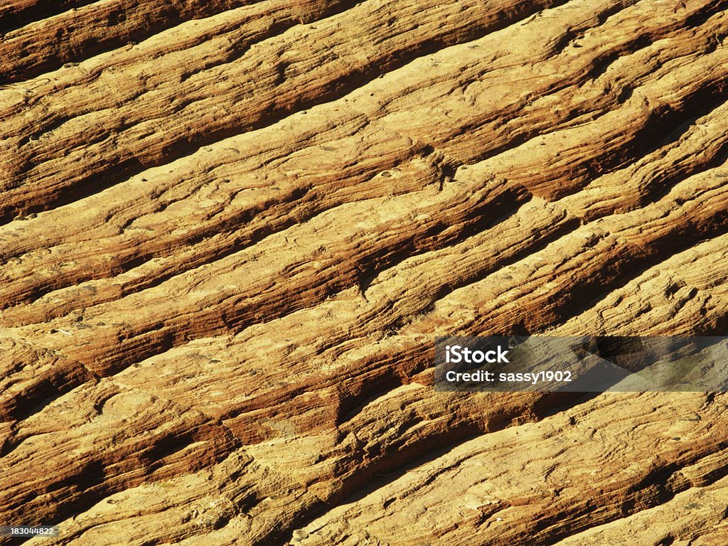 Zion National Park Checkerboard Mesa Geology "Deep furrows have been cut, like a checkerboard, taking millions of years to carve in the Navajo sandstone. The horizontal furrows were cut during the Jurassic period by wind-blown sands of the huge ancient sand dunes that spread out over the land in place of the massive monoliths you see in Zion National Park today. A freeze and thaw process is responsible for gradually widening the furrows along vertical joints. The vertical slits were formed much later after brittle rock had formed." Arrangement Stock Photo